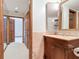 Bathroom featuring classic wood cabinets, and a shower with a sliding glass door at 42 Grenewood Ln, Haines City, FL 33844