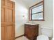 Bathroom features a sink with modern fixtures, a toilet, and a window view at 42 Grenewood Ln, Haines City, FL 33844