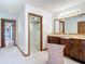 Bathroom featuring a double vanity with a tiled countertop, a walk-in shower with glass surround, and natural light at 42 Grenewood Ln, Haines City, FL 33844