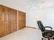 Bedroom features two closet, white walls, ceiling fan, and chair at 42 Grenewood Ln, Haines City, FL 33844