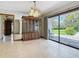 Spacious dining room with a decorative hutch, elegant chandelier, and sliding glass doors to the patio at 42 Grenewood Ln, Haines City, FL 33844