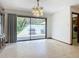 Bright dining room with a modern chandelier, large sliding glass doors to the backyard patio with BBQ at 42 Grenewood Ln, Haines City, FL 33844
