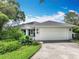 Charming single-story home featuring a well-maintained lawn and an attached two-car garage at 42 Grenewood Ln, Haines City, FL 33844