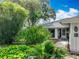 Lush front yard with tropical plants and a walkway leading to the front door of a well-maintained home at 42 Grenewood Ln, Haines City, FL 33844