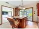 Open-concept kitchen with island seating, seamlessly connected to living area and screened patio at 42 Grenewood Ln, Haines City, FL 33844