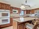 Spacious kitchen with wooden cabinets, a large island, stainless steel appliances and tiled floors at 42 Grenewood Ln, Haines City, FL 33844