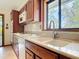 Kitchen featuring wooden cabinets, a window overlooking the backyard, and modern appliances at 42 Grenewood Ln, Haines City, FL 33844