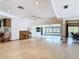 Bright, tiled living space with a ceiling fan, and multiple access points to other rooms at 42 Grenewood Ln, Haines City, FL 33844