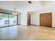 Bright living room with tile flooring, natural light, and sliding door access to the backyard at 42 Grenewood Ln, Haines City, FL 33844
