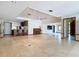Large, open-concept living area with tiled floors, recessed lighting, and a bar area at 42 Grenewood Ln, Haines City, FL 33844