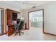 Bright home office featuring marble floors, built-in shelving, and views into the connected living spaces at 42 Grenewood Ln, Haines City, FL 33844