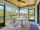 Screened-in patio with outdoor seating offers views of the green, landscaped yard at 42 Grenewood Ln, Haines City, FL 33844