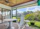 Screened outdoor patio with comfortable seating and views of the lush green lawn and landscaping at 42 Grenewood Ln, Haines City, FL 33844