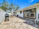 Paver patio featuring outdoor dining, a grill, and sliding glass doors leading indoors at 42 Grenewood Ln, Haines City, FL 33844