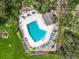 Aerial view of a community pool, many lounge chairs with lush surrounding landscaping at 42 Grenewood Ln, Haines City, FL 33844