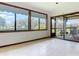 Bright sunroom with large windows, tiled floors, and access to an outdoor area at 42 Grenewood Ln, Haines City, FL 33844