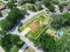 Aerial view of property with pool, solar panels, mature trees, and lush landscaping at 4333 Shadow Wood Way, Winter Haven, FL 33880