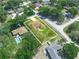 Aerial view of the property with solar panels, fenced yard, pool and mature trees at 4333 Shadow Wood Way, Winter Haven, FL 33880