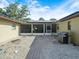Backyard with a screened-in patio, solar panels on roof, and a brick walkway at 4333 Shadow Wood Way, Winter Haven, FL 33880