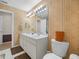 Bathroom features a double vanity sink, large mirror and decorative wall paper at 4333 Shadow Wood Way, Winter Haven, FL 33880