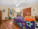 Cozy bedroom with laminate flooring, ceiling fan, and natural light from the window at 4333 Shadow Wood Way, Winter Haven, FL 33880