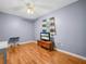 This bedroom features wood floors, a TV, and a single window with curtains at 4333 Shadow Wood Way, Winter Haven, FL 33880