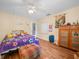 Cozy bedroom with laminate flooring, ceiling fan, and natural light at 4333 Shadow Wood Way, Winter Haven, FL 33880