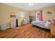 Bright bedroom featuring laminate flooring, natural light, and ceiling fan at 4333 Shadow Wood Way, Winter Haven, FL 33880