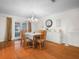Elegant dining room with hardwood floors, a chandelier, and access to the screened-in pool area at 4333 Shadow Wood Way, Winter Haven, FL 33880