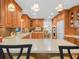 Well-appointed kitchen with custom cabinetry, tile backsplash, and views into the dining room at 4333 Shadow Wood Way, Winter Haven, FL 33880