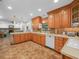 Open kitchen layout with custom cabinetry, tile floors, and a view of the adjacent living area at 4333 Shadow Wood Way, Winter Haven, FL 33880