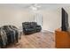 Living room with a bed, leather reclining sofa, and a ceiling fan at 4333 Shadow Wood Way, Winter Haven, FL 33880