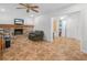 Inviting living area featuring a stone fireplace, tile floors, and an adjacent sitting area at 4333 Shadow Wood Way, Winter Haven, FL 33880