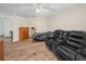 Living room with bed, leather reclining sofa, and wood-look floors at 4333 Shadow Wood Way, Winter Haven, FL 33880