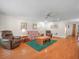 Cozy living room with hardwood floors, a ceiling fan, and comfortable seating arrangement at 4333 Shadow Wood Way, Winter Haven, FL 33880