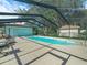 View of the screened-in pool with several chairs around at 4333 Shadow Wood Way, Winter Haven, FL 33880