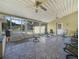 Screened-in sunroom with ceiling fans and several chairs at 4333 Shadow Wood Way, Winter Haven, FL 33880