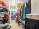 Long walk-in closet with shelving and hanging racks for storage at 4333 Shadow Wood Way, Winter Haven, FL 33880