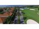 Beautiful aerial view of a golf course community with lush landscaping, palm trees lining the street, and a tranquil lake at 4480 Turnberry Ln, Lake Wales, FL 33859