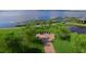 Beautiful aerial view showcasing lush landscaping and the American flag over a memorial near the lake at 4480 Turnberry Ln, Lake Wales, FL 33859