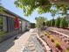 Spacious backyard featuring a brick paver patio, landscaped garden beds, and privacy trees at 4480 Turnberry Ln, Lake Wales, FL 33859
