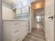 Bathroom featuring a large white vanity with stylish fixtures and wood-look flooring at 4480 Turnberry Ln, Lake Wales, FL 33859