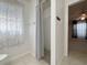Clean bathroom with a walk-in shower, neutral tile, modern fixtures, and natural light from a window at 4480 Turnberry Ln, Lake Wales, FL 33859