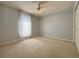 Light and airy bedroom with neutral paint, carpet and a ceiling fan at 4480 Turnberry Ln, Lake Wales, FL 33859