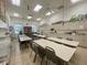 Brightly lit craft room with ample table space, storage cabinets, and natural light at 4480 Turnberry Ln, Lake Wales, FL 33859