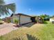 Charming single-story home with a brick-paved walkway and well-maintained lawn and garden at 4480 Turnberry Ln, Lake Wales, FL 33859