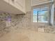 Close-up of the kitchen backsplash with quartz countertops and a sunny view at 4480 Turnberry Ln, Lake Wales, FL 33859