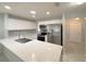 Bright kitchen features white cabinets, stainless steel appliances, and a mosaic backsplash, plus eat-in island at 4480 Turnberry Ln, Lake Wales, FL 33859