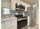 Well-equipped kitchen featuring white cabinets, a stainless steel oven, and stylish backsplash tiles at 4480 Turnberry Ln, Lake Wales, FL 33859