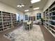 Cozy library with extensive bookshelves, a large table, and inviting decor at 4480 Turnberry Ln, Lake Wales, FL 33859